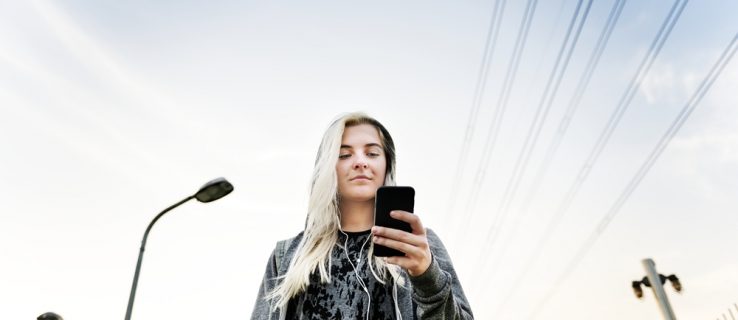 Young Woman Skater Browsing Phone Concept