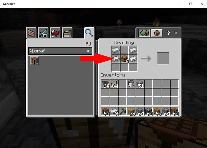 Placing two Iron Ingots in the side middle slots of the crafting grid in Minecraft